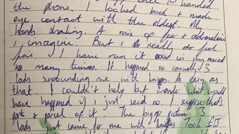 Blue biro has been used to write a diary entry in a book with lined paper