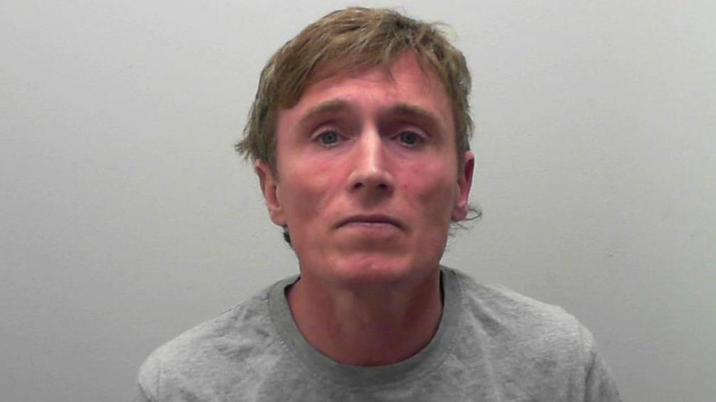 Anthony Winton in a custody image issued by North Yorkshire Police. He is wearing a grey top and has light brown hair.