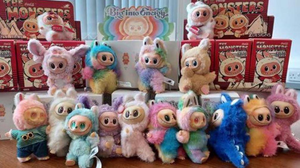 A range of colourful fake Labubu dolls are pictured together with their boxes after being seized.