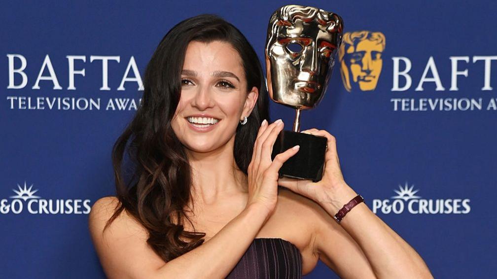 Marisa Abela, winner of the Leading Actress Award for 'Industry', lifts her Bafta on Sunday