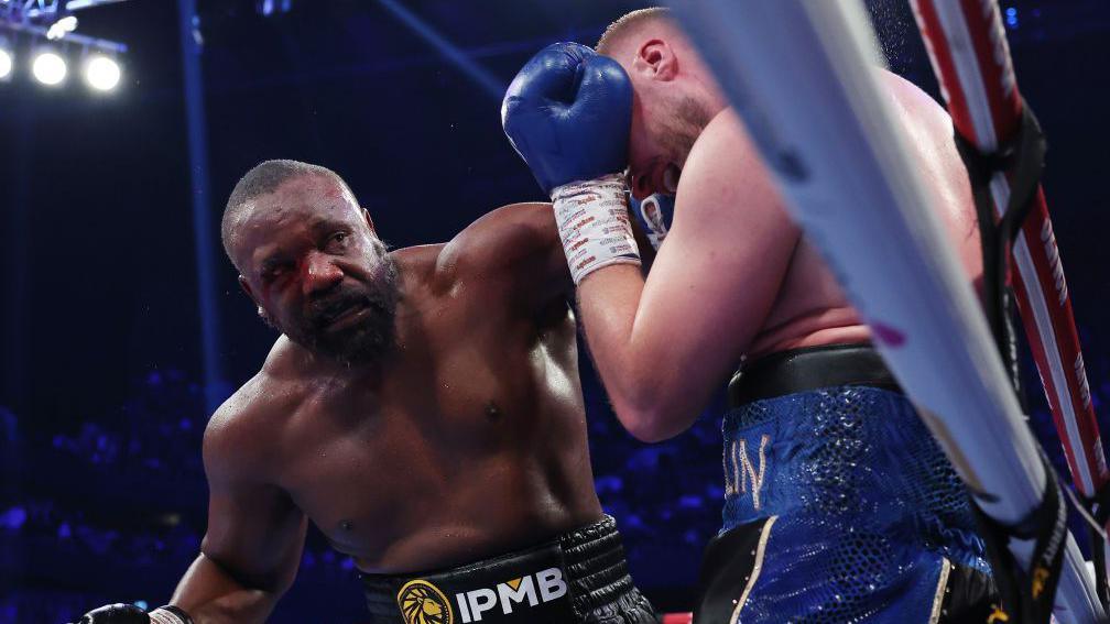 Derek Chisora throws a left hook against Otto Wallin