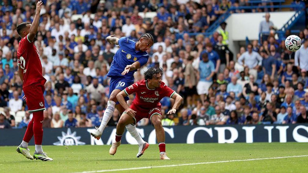 Joao Pedro leaps above a Real Sociedad player to head Chelsea's second goal