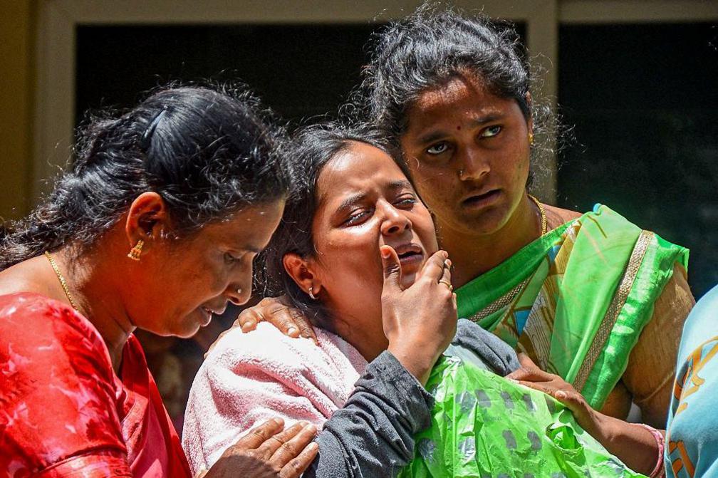 Family members of a victim who died during the stampede outside the M. Chinnaswamy Stadium grieve in front of her body at their residence in the Yelahanka locality in Bengaluru on June 5, 2025. Virat Kohli said he was lost for words after celebrations of a dream IPL title turned to tragedy when 11 mainly young cricket fans were crushed to death in Bengaluru. Hundreds of thousands had packed the streets on June 4 to welcome home their hero Kohli and the Royal Challengers Bengaluru (RCB) after they had beaten Punjab Kings a day earlier in a thrilling Indian Premier League final. (Photo by AFP) (Photo by -/AFP via Getty Images)