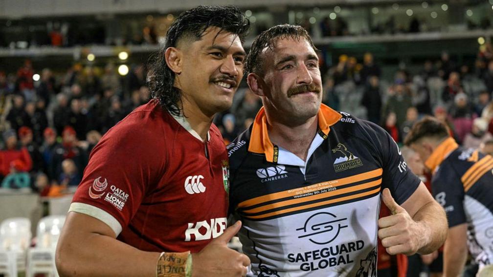 British and Irish Lions' Jack Conan (right) poses for photos after exchanging jerseys with ACT Brumbies' Tuaina Taii Tualima