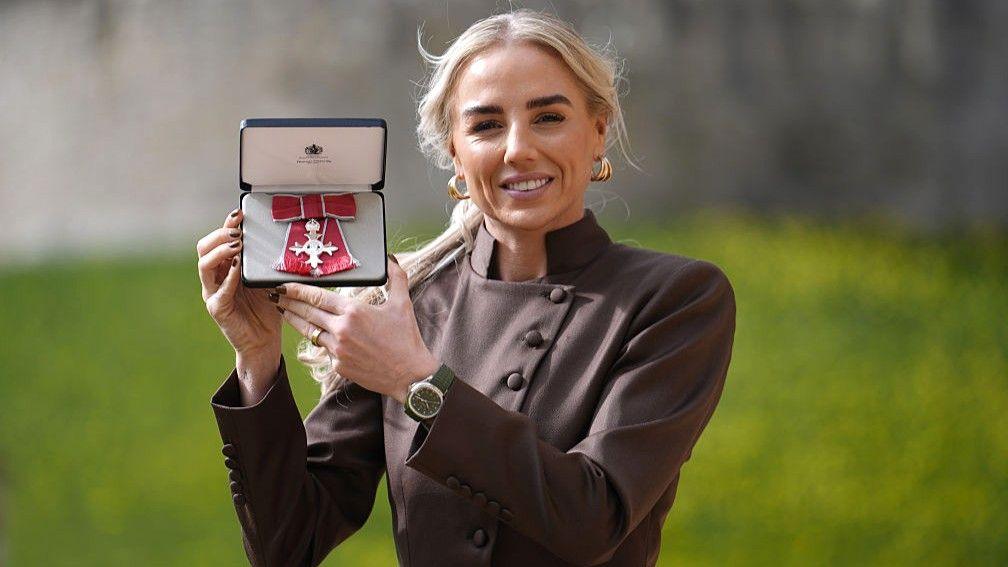 Alex Greenwood holds her MBE outside Windsor Castle