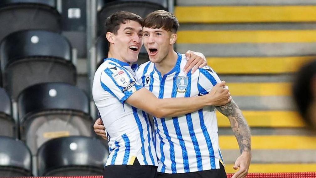 Charlie McNeill hugs a team-mate