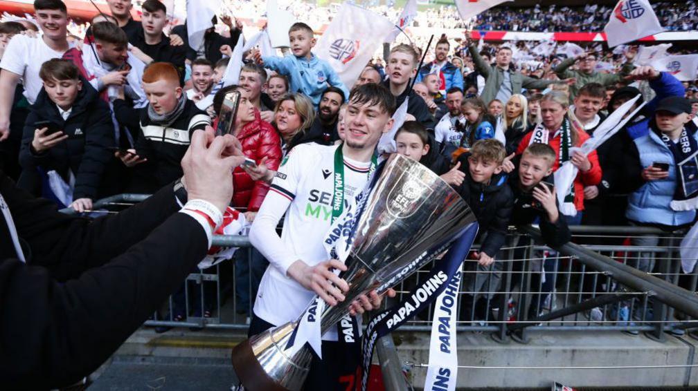 Conor Bradley celebrates with the Papa John's Trophy