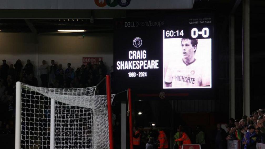 A tribute to Craig Shakespeare is displayed on the big screen