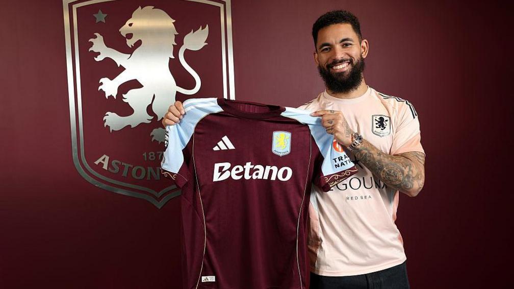 Douglas Luiz of Aston Villa poses