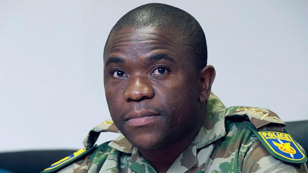 Nhlanhla Mkhwanazi is seen wearing military-like police uniform during a briefing