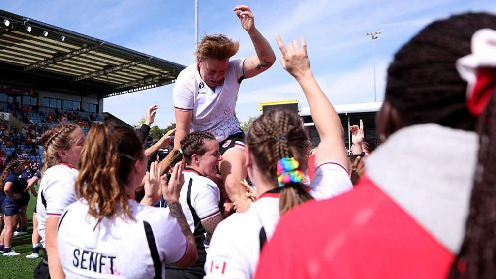 Tyson Beukeboom is lifted up by her team-mates