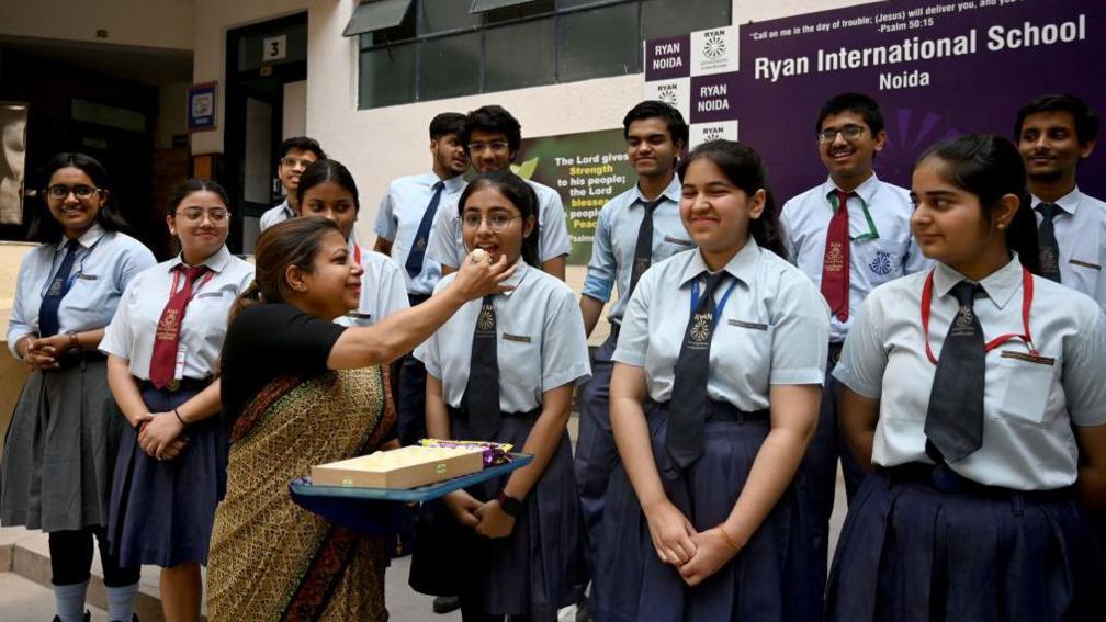 Students celebrate their results in the CBSE Class 12 board exam, at Ryan International School.