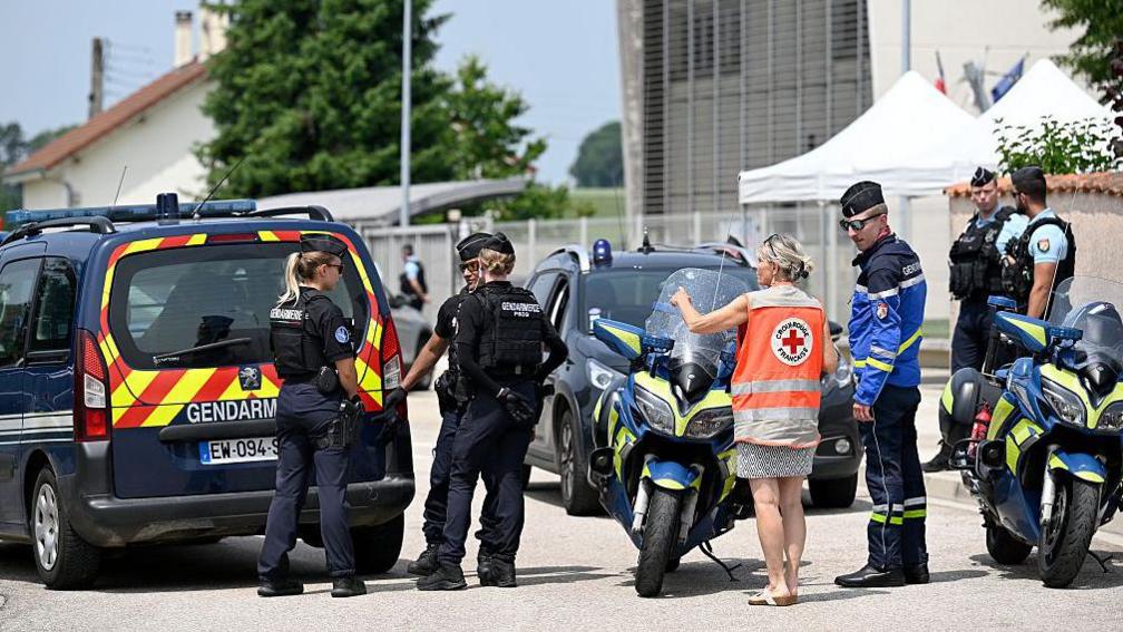 French gendarmes control the access to a secondary school after a 31-year-old teaching assistant was stabbed with a knife by a 15-year-old pupil during a bag search in Nogent, eastern France, on June 10, 2025