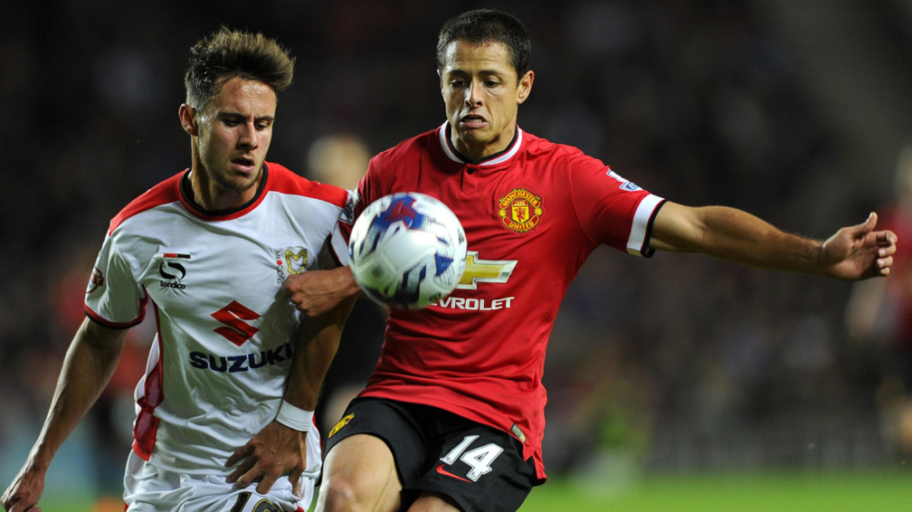 George Baldock in action for MK Dons against Manchester United in 2014