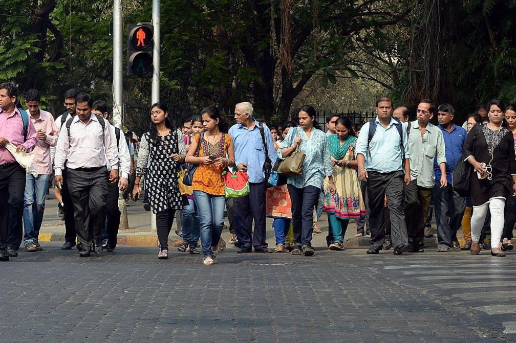 Indian residents walk at a pedestrian crossing in Mumbai 