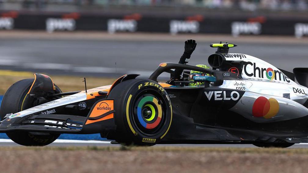 McLaren's Lando Norris waves to the fans after winning the British Grand Prix