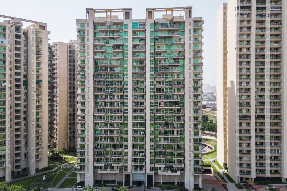 Air conditioner units placed near windows of residential apartment building in Greater Noida, Uttar Pradesh, India, on Sunday, May 7, 2023