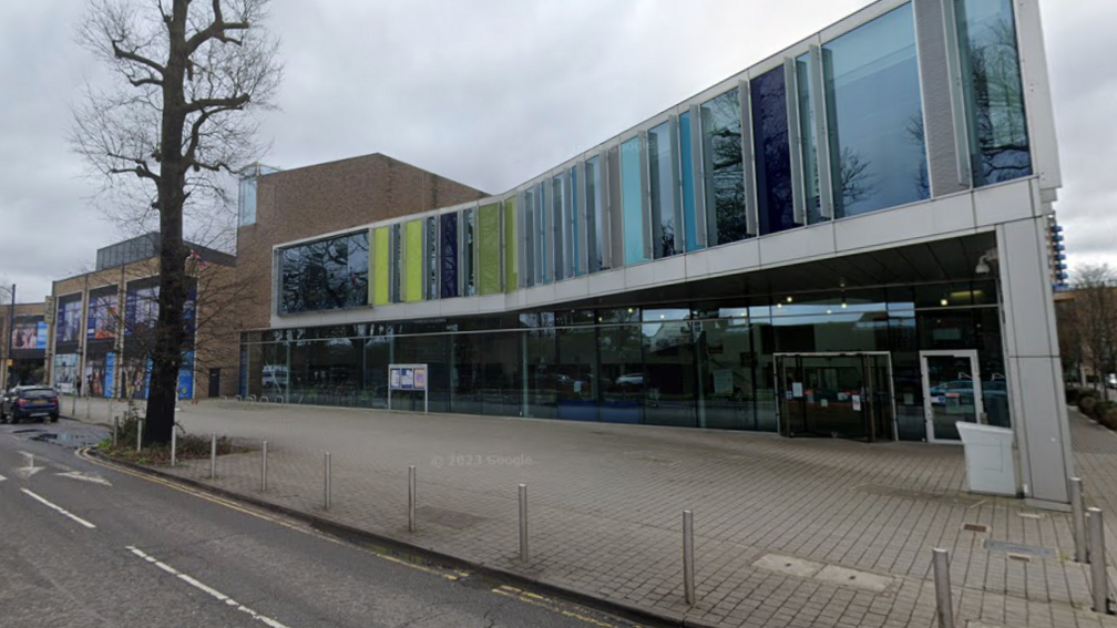 A large council building under grey skies.