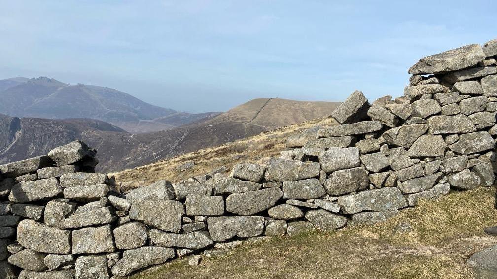 A close up of damage to the wall. You can see that some stones are missing