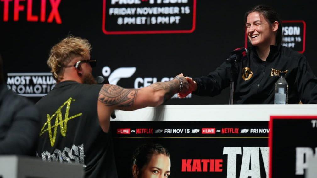 Jake Paul shakes the hand of Katie Taylor 