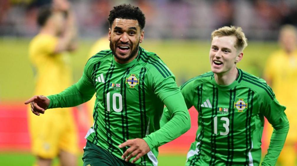 Jamie Reid celebrates scoring against Romania