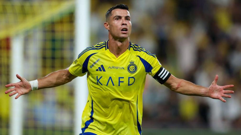 Cristiano Ronaldo celebrates a goal for Al-Nassr with arms outstretched