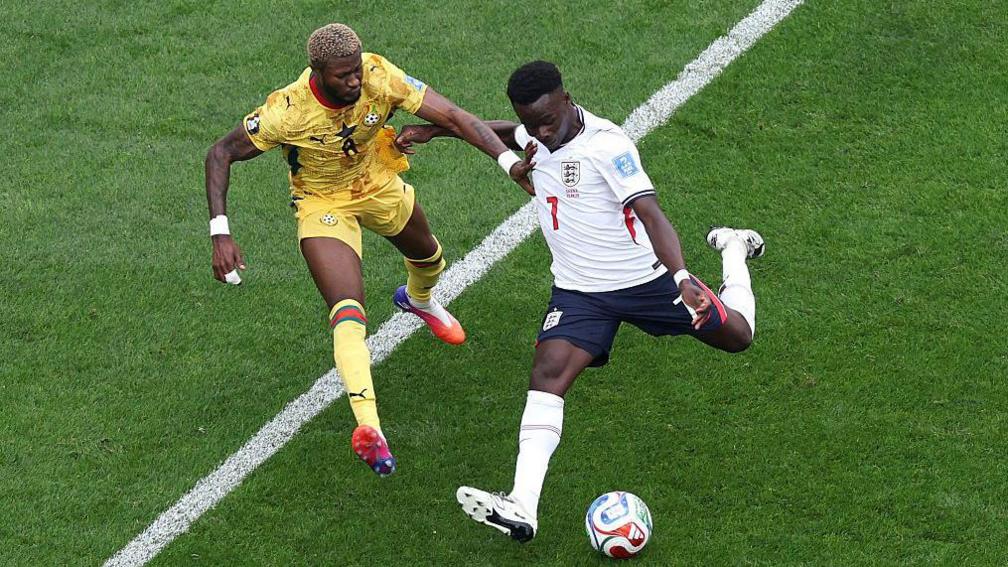 Bukayo Saka #7 of England shoots while Kwasi Sibo #8 of Ghana attempts to block during the FIFA World Cup 2026 Group L match between England and Ghana at Boston Stadium on June 23, 2026 in Foxborough, Massachusetts.