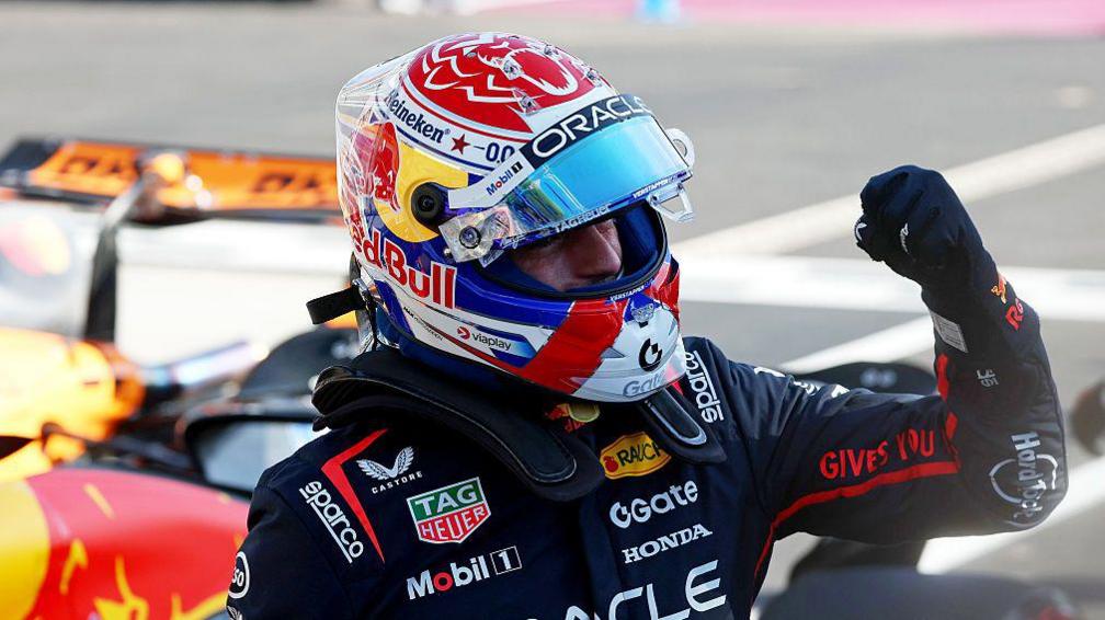 Max Verstappen clenches his left fist in celebration after climbing out of his Red Bull, having taken pole position for the Italian Grand Prix