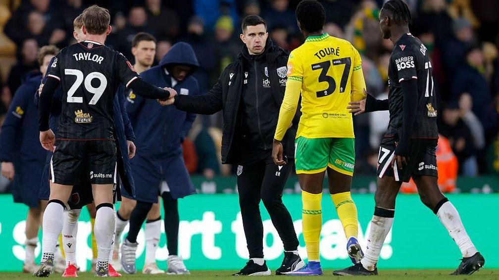 West Bromwich Albion head coach Eric Ramsay talks to his players on the pitch after their FA Cup defeat by Norwich