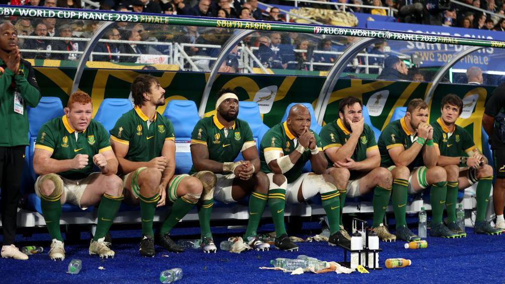 South Africa players Steven Kitshoff, Eben Etzebeth, Siya Kolisi, Mbongeni Mbonambi, Frans Malherbe, Duane Vermeulen and Franco Mostert look on pensively from the bench during the World Cup final.