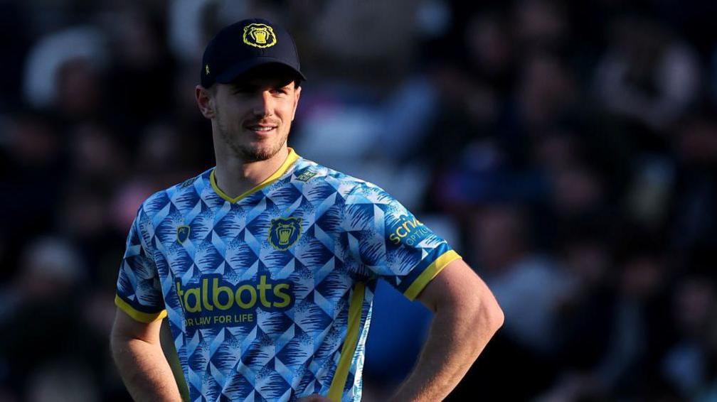 George Garton stands with hands on hips looking into the distance in his Birmingham Bears kit during a match