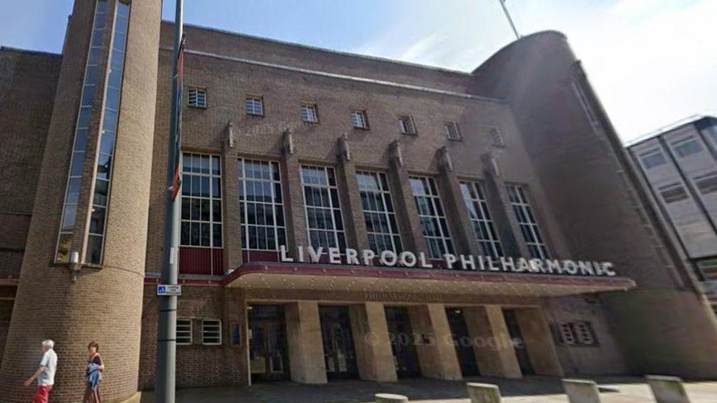 Exterior of the Art Deco Liverpool Philharmonic Hall. A brick building with several entrances.
