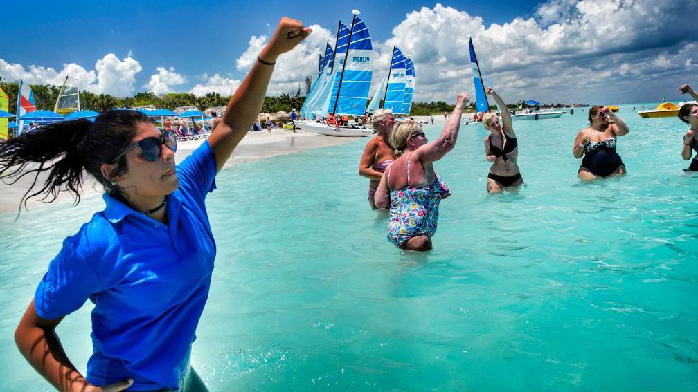 Canadian tourists taking part in an exercise class in the sea off a beach in Varadero, Cuba