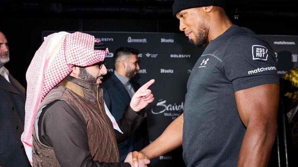 Turki Alalshikh shakes hands with Anthony Joshua