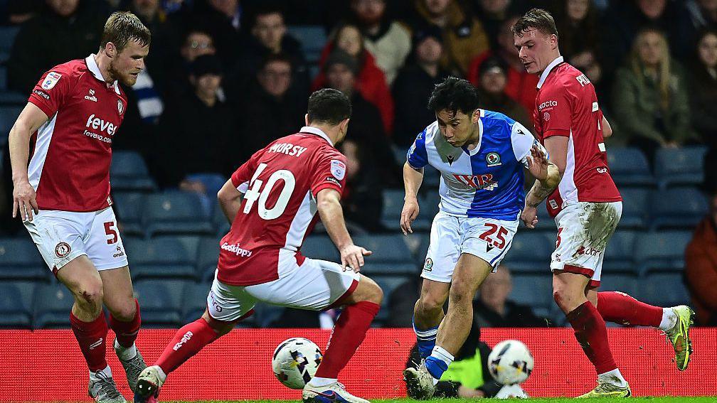 Ryoya Morishita vies for possession with Bristol City's Sam Morsy.