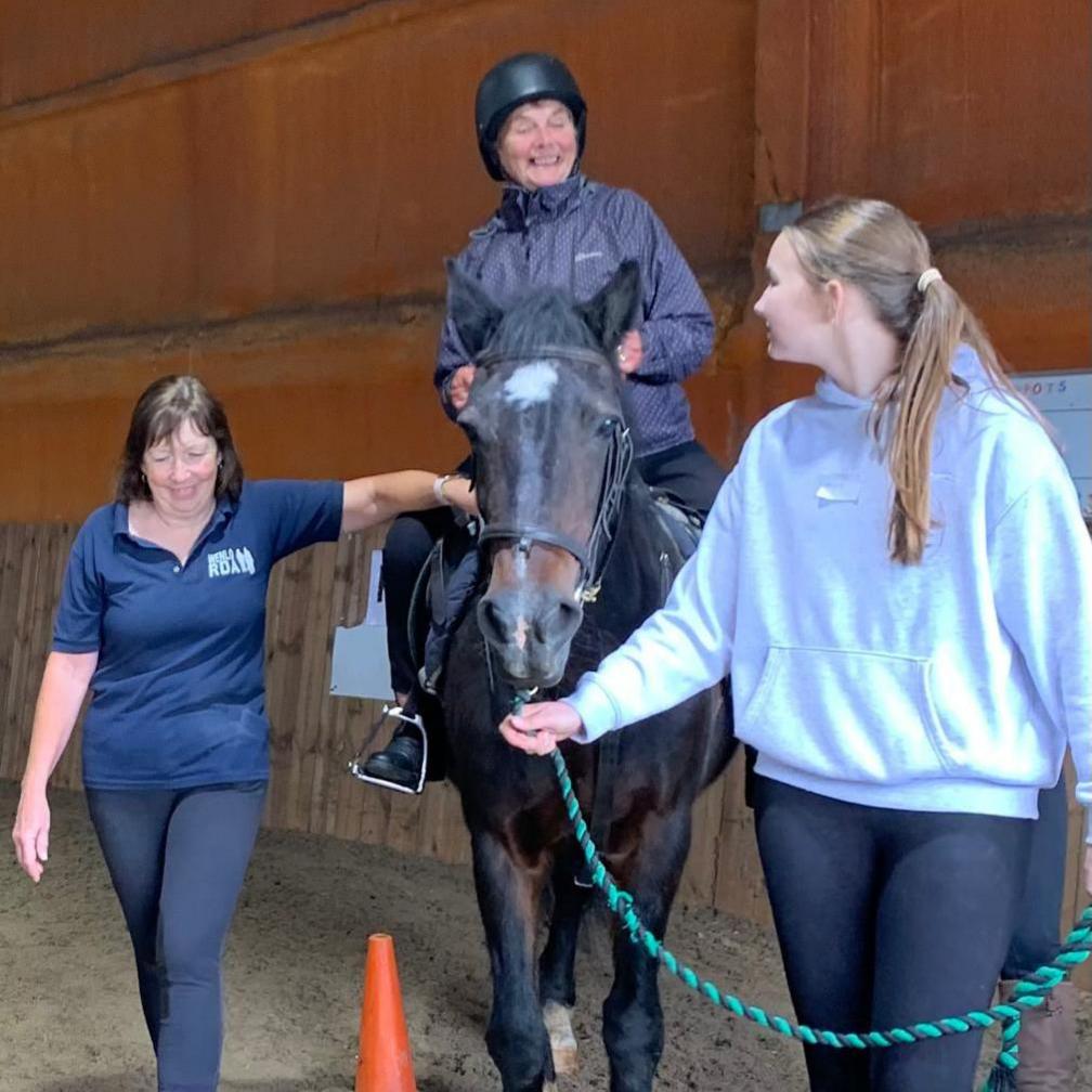 Staff at Wenlo helping an 82-year-old woman ride a horse