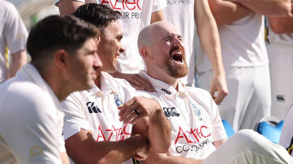 Durham's David Bedingham and Ben Raine share a laugh while sat alongside each other on the bench at the club's media call