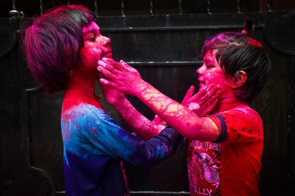 Children are putting coloured powder on each other as they celebrate the Holi festival, the festival of colours, in Kolkata, India, on March 25, 2024