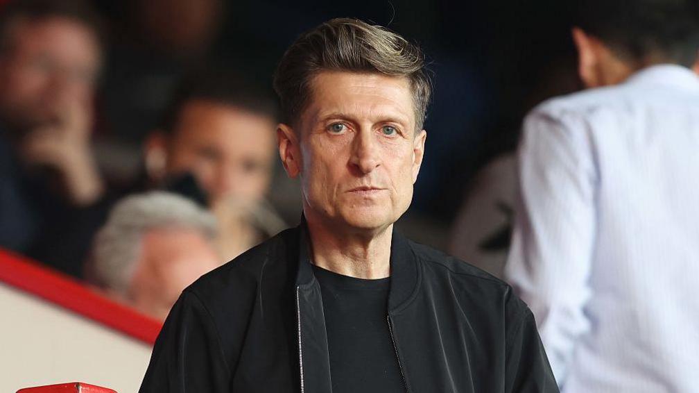Steve Parish wearing a black T-shirt and jacket