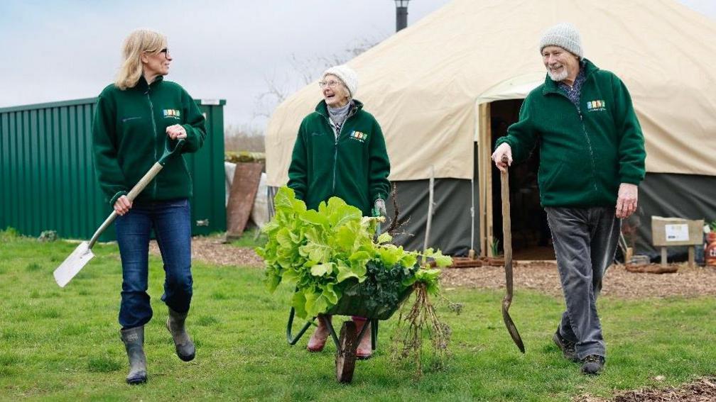 Volunteers with a wheelbarrow 