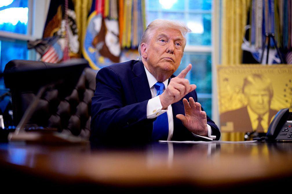 President Donald Trump takes a question from a reporter before signing executive orders in the Oval Office at the White House on September 19, 2025 in Washington, DC. Trump signed two executive orders, establishing the "Trump Gold Card" and introducing a $100,000 fee for H-1B visas. 