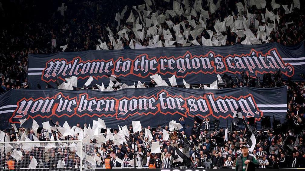 Newcastle fans unfurl a banner saying 'Welcome to the region's capital - you've been gone for so long!'