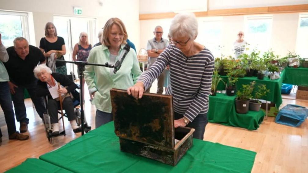 Residents watch as the time capsule is opened