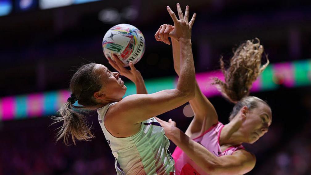 Hannah Joseph of Loughborough Lightning reaches for the ball with Gracie Smith of London Pulse during the Netball Super League 2025 Grand Final match 
