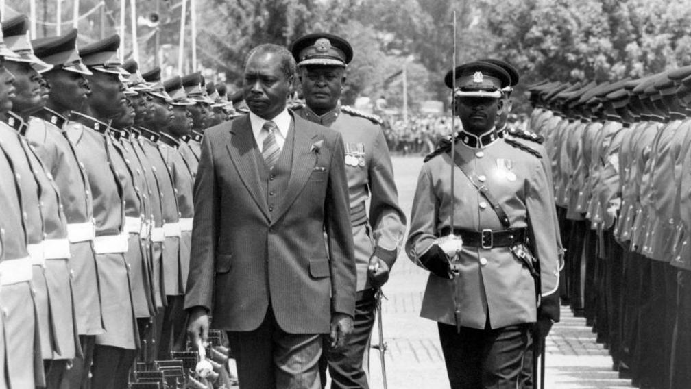 A black and white image of Daniel arap Moi inspecting a guard of honour after he became Kenya's second president in 1978
