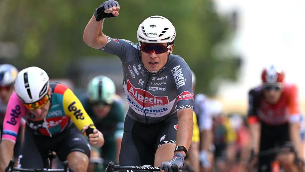 Belgium's Jasper Philipsen punches nan aerial successful ceremony of his shape victory
