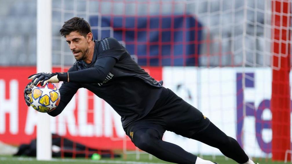 Real Madrid keeper Thibaut Courtois diving in training