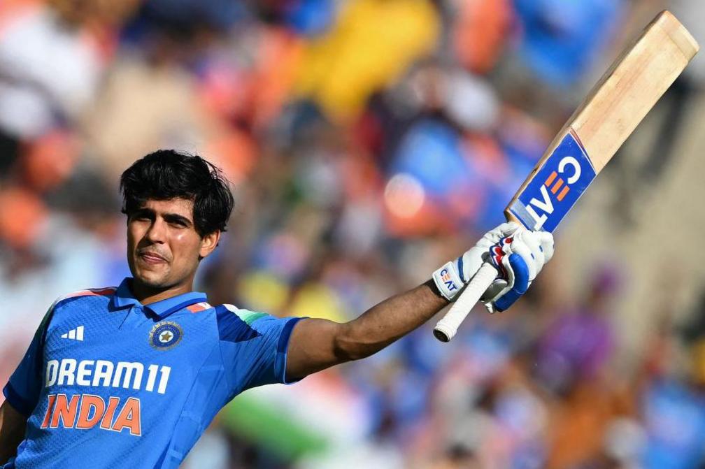 India's Shubman Gill celebrates after scoring a century (100 runs) during the third one-day international (ODI) cricket match between India and England at the Narendra Modi Stadium in Ahmedabad on February 12, 2025.