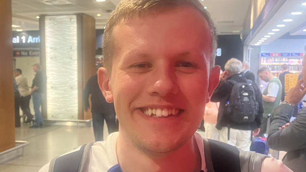 Oliver Watkinson in Manchester Airport arrivals hall