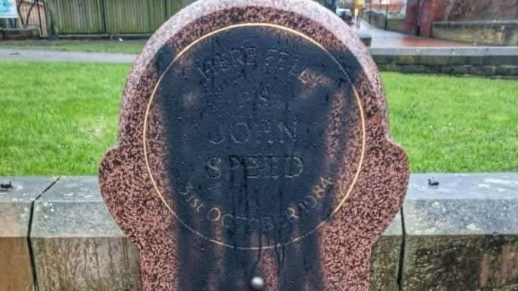 Memorial stone with black paint on it